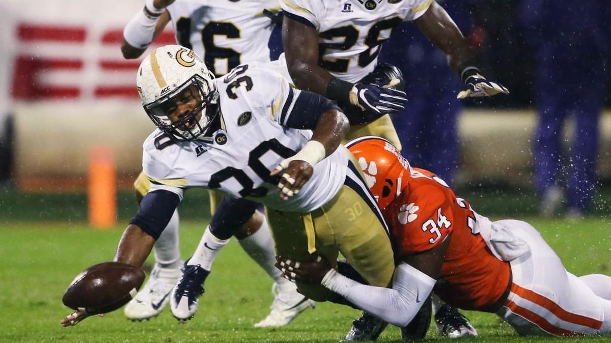 Georgia Tech running back KirVonte Benson (30) fumbles as he is brought down by Clemson linebacker Kendall Joseph (34) in the first half of their game Saturday in Clemson, South Carolina.