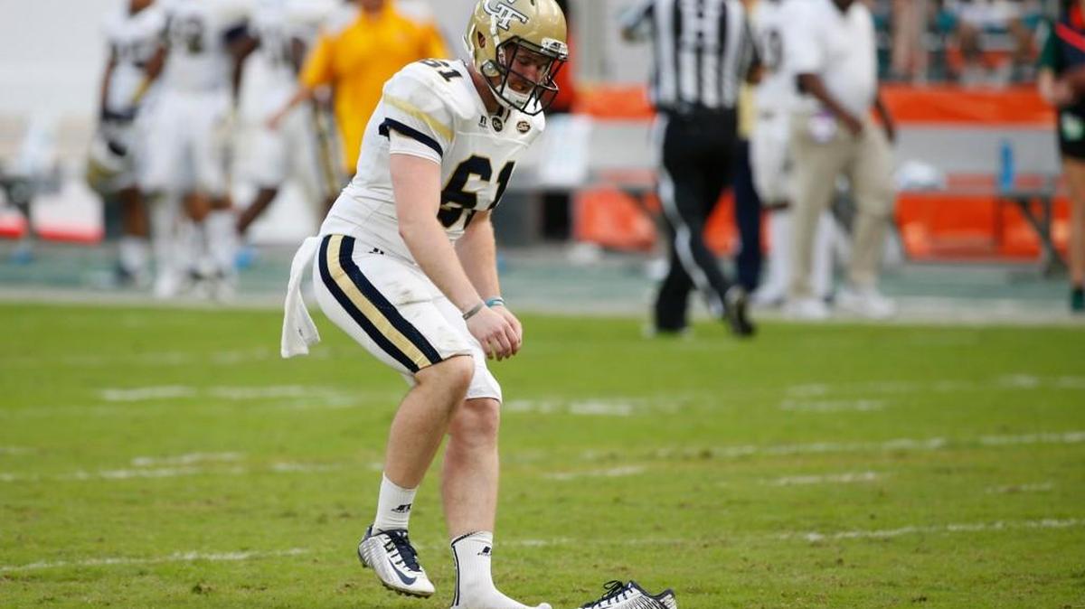 Georgia Tech long snapper Casey Wilson retrieves his shoe after a kick in his team’s game against Miami on Oct. 14 in Miami Gardens, Florida.