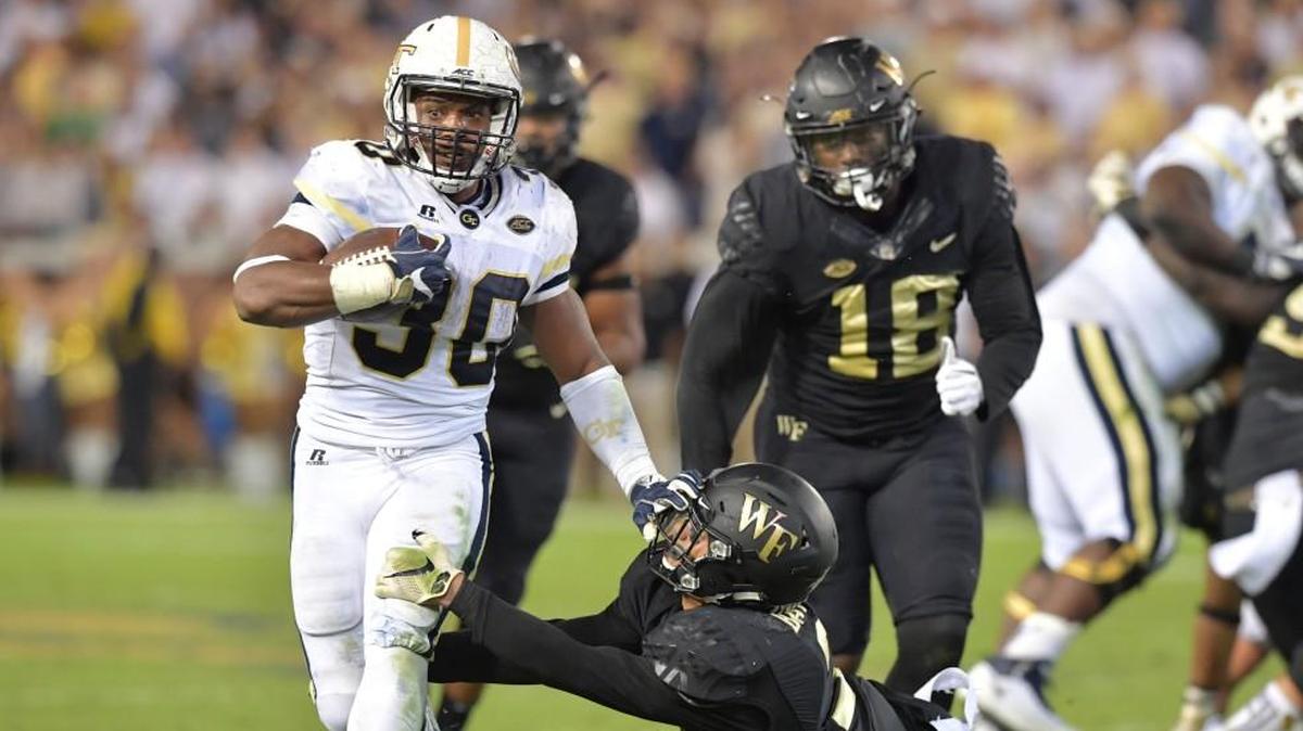 Georgia Tech running back KirVonte Benson (30) eludes a tackle by Wake Forest defensive back Jessie Bates III (3) in the first half at Bobby Dodd Stadium in Atlanta on Saturday, Oct. 21, 2017. The host Yellow Jackets won, 38-24.