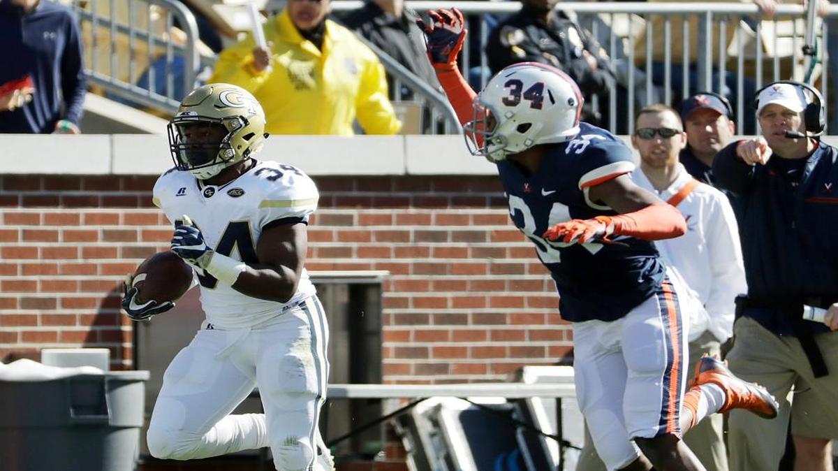 Georgia Tech’s Marcus Marshall runs the ball for a touchdown against Virginia’s Bryce Hall (34) in the second quarter Saturday in Atlanta.