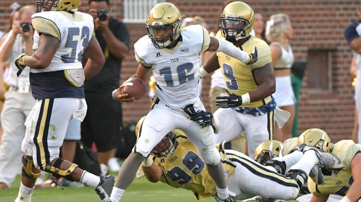 Georgia Tech White Team quarterback TaQuon Marshall (16) runs past Gold Team defensive lineman Desmond Branch (99) during Friday’s spring game.