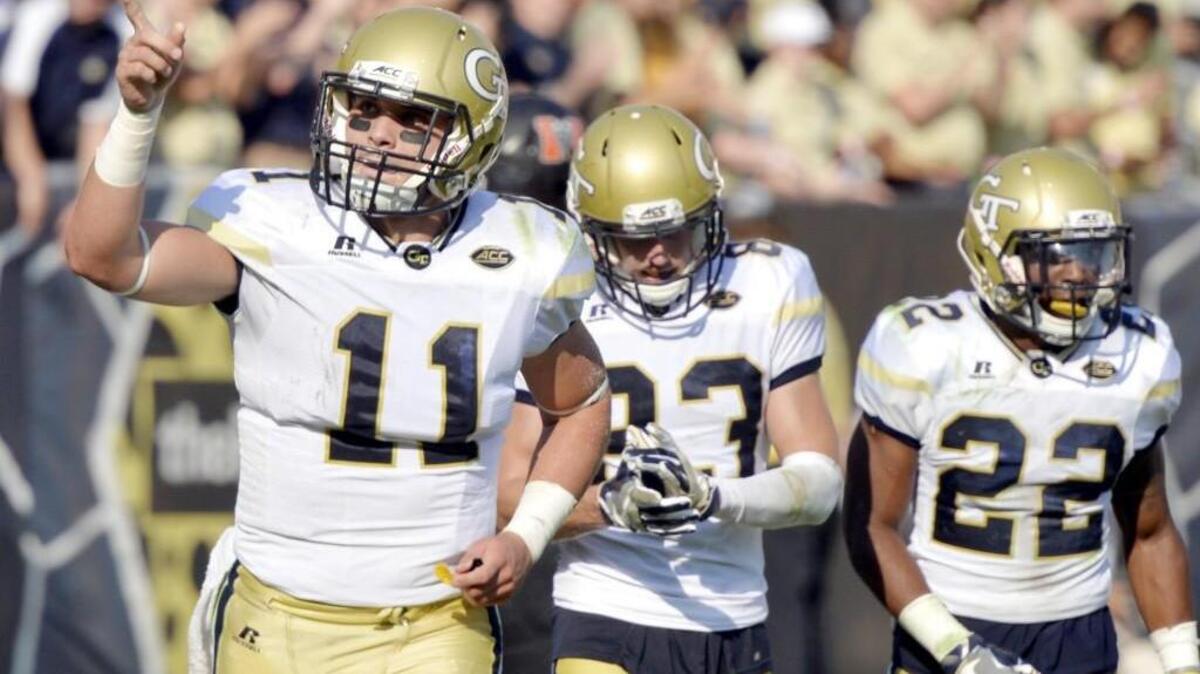 Georgia Tech quarterback Matthew Jordan (11) pints to the stands after a second half touchdown against Mercer Saturday.