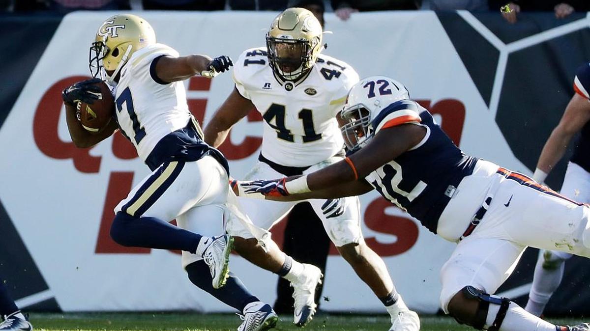 Georgia Tech’s Lance Austin, left, returns an interception for a touchdown against Virginia on Saturday.