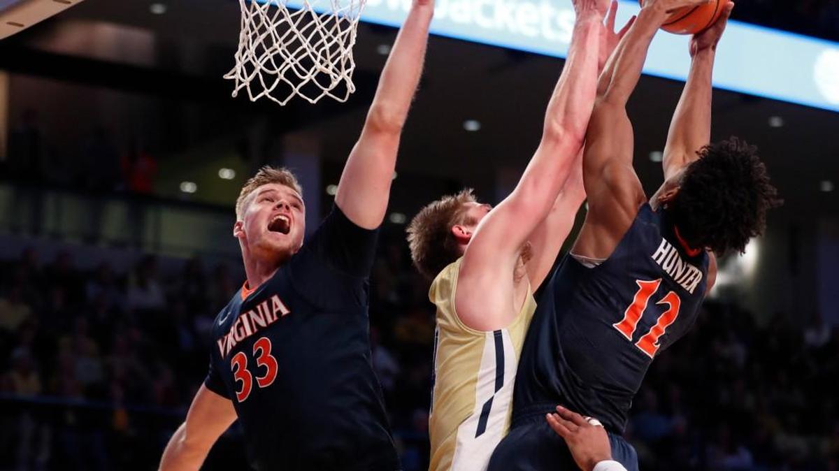 Georgia Tech center Ben Lammers (44) battles Virginia’s De’Andre Hunter (12) and Jack Salt (33) for a rebound during the first half of their game Thursday in Atlanta.