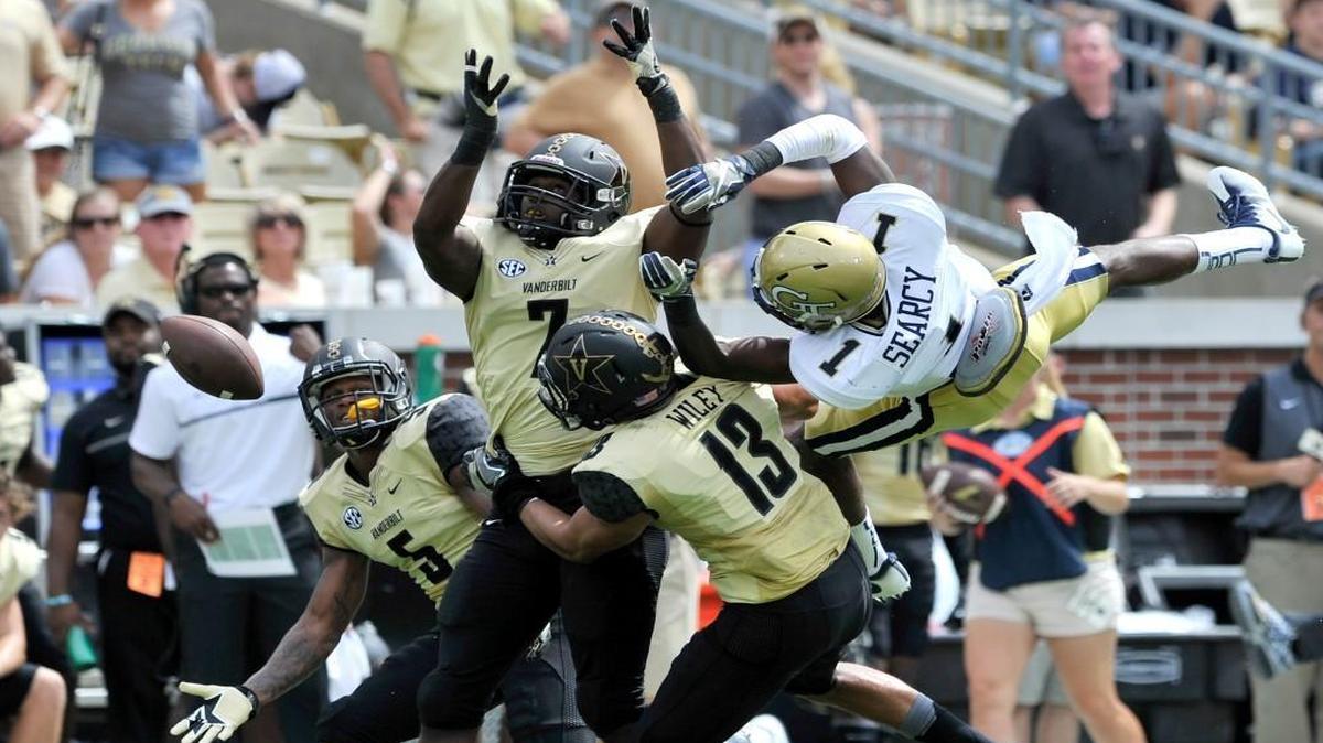 Georgia Tech receiver Qua Searcy gets up-ended by a host of Vanderbilt defenders in action Saturday at Bobby Dodd Stadium.