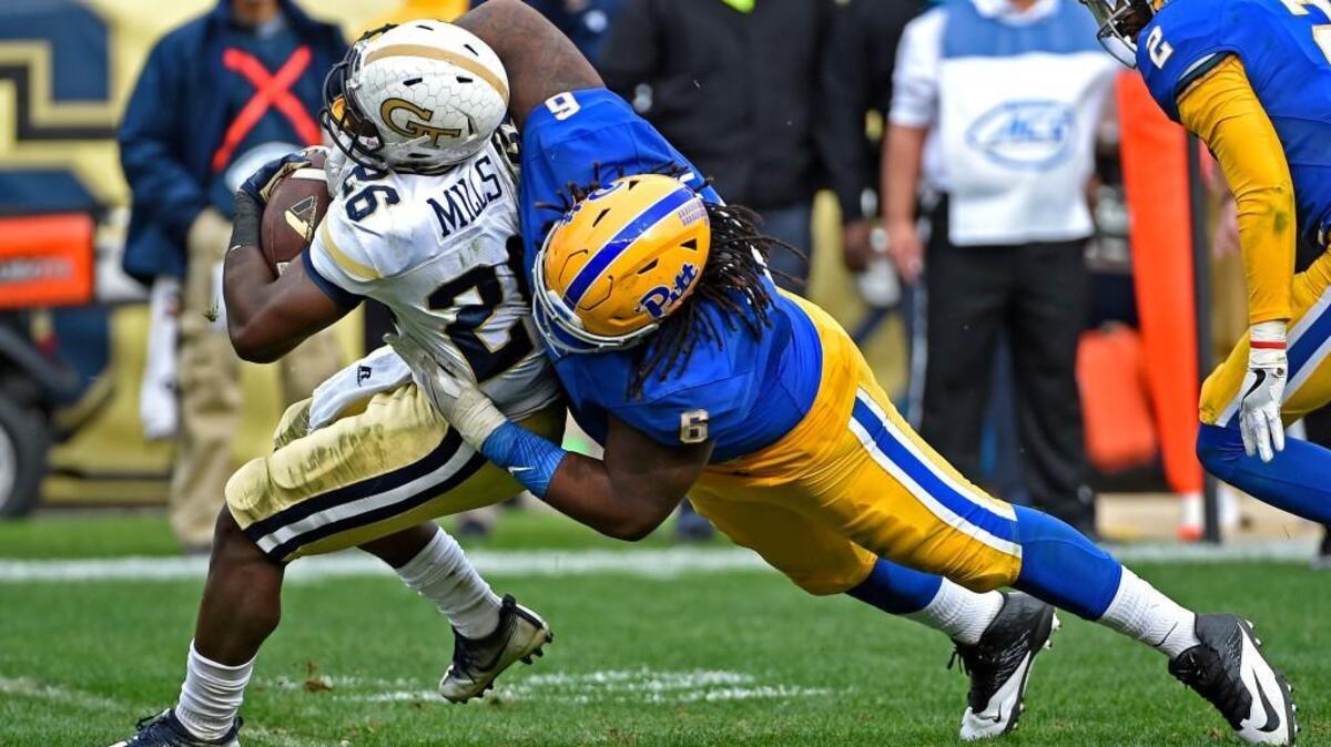 Pittsburgh defensive lineman Tyrique Jarrett (6) tackles Georgia Tech running back Dedrick Mills (26) for a loss during the second half Saturday.