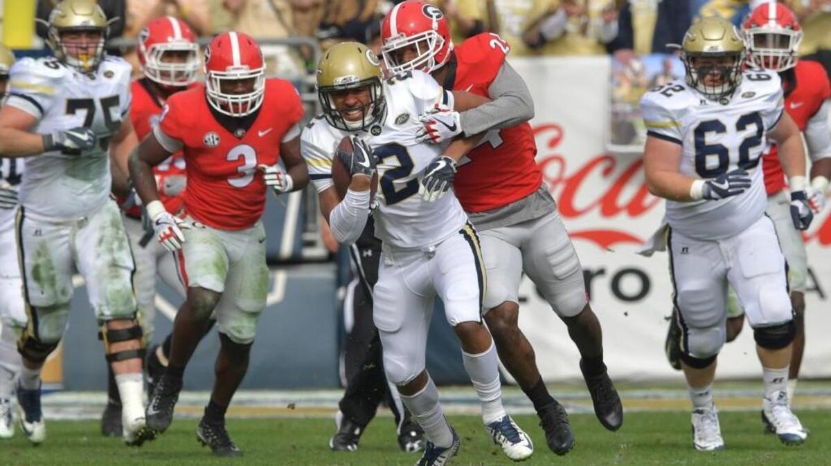 Georgia Tech wide receiver Ricky Jeune (2) eludes a tackle by Georgia safety Dominick Sanders (24) in their game Nov. 25 at Bobby Dodd Stadium in Atlanta.