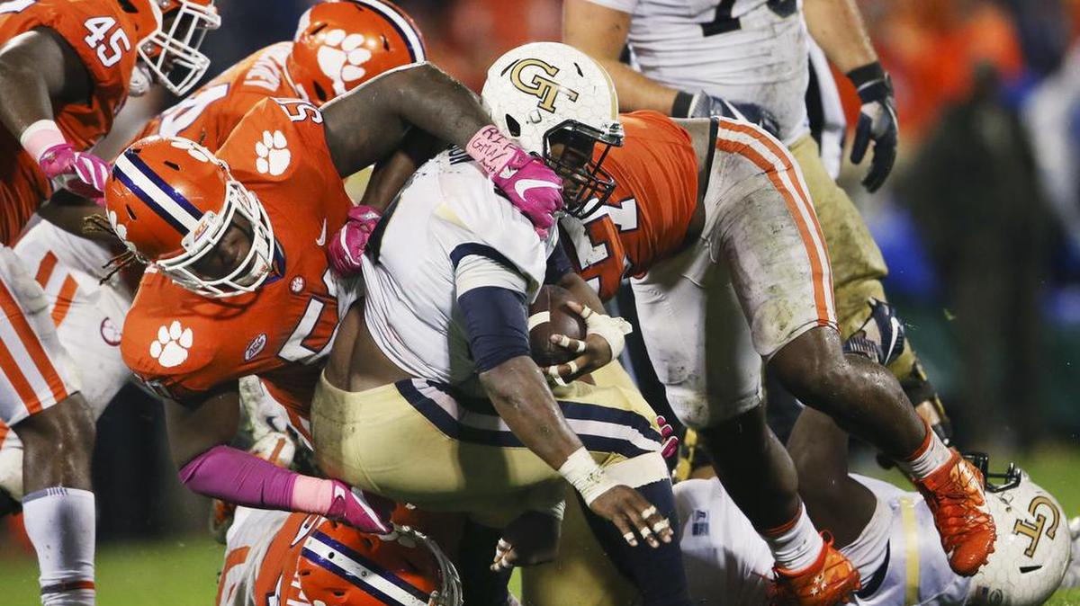 Georgia Tech running back KirVonte Benson (30) is stopped by the Clemson defense including Clemson defensive tackle Jabril Robinson (50) in the second half of Saturday’s game. Still, Benson surpassed 100 rushing yards for the fifth time this season.
