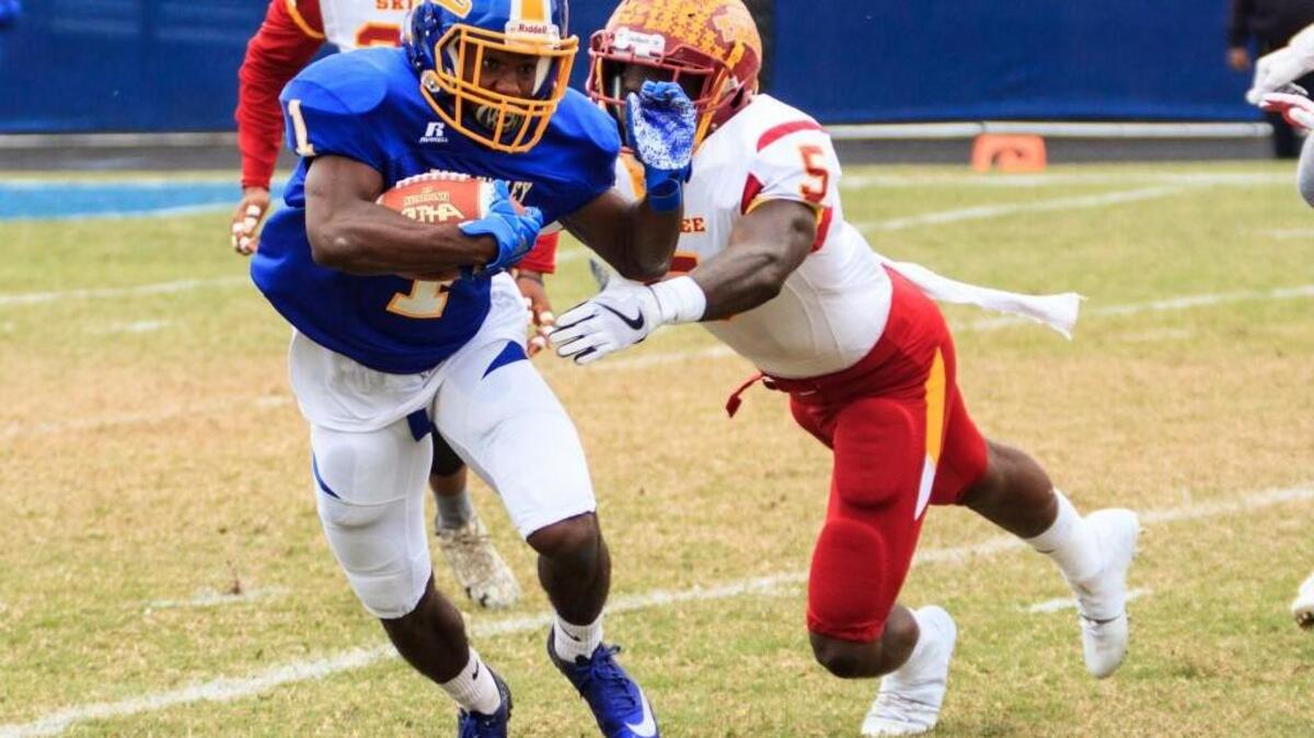 Fort Valley State University's Lorenzo Smothers (1) avoids the tackle by Tuskegee's Osband Thompson (5) In their SIAC championship game.