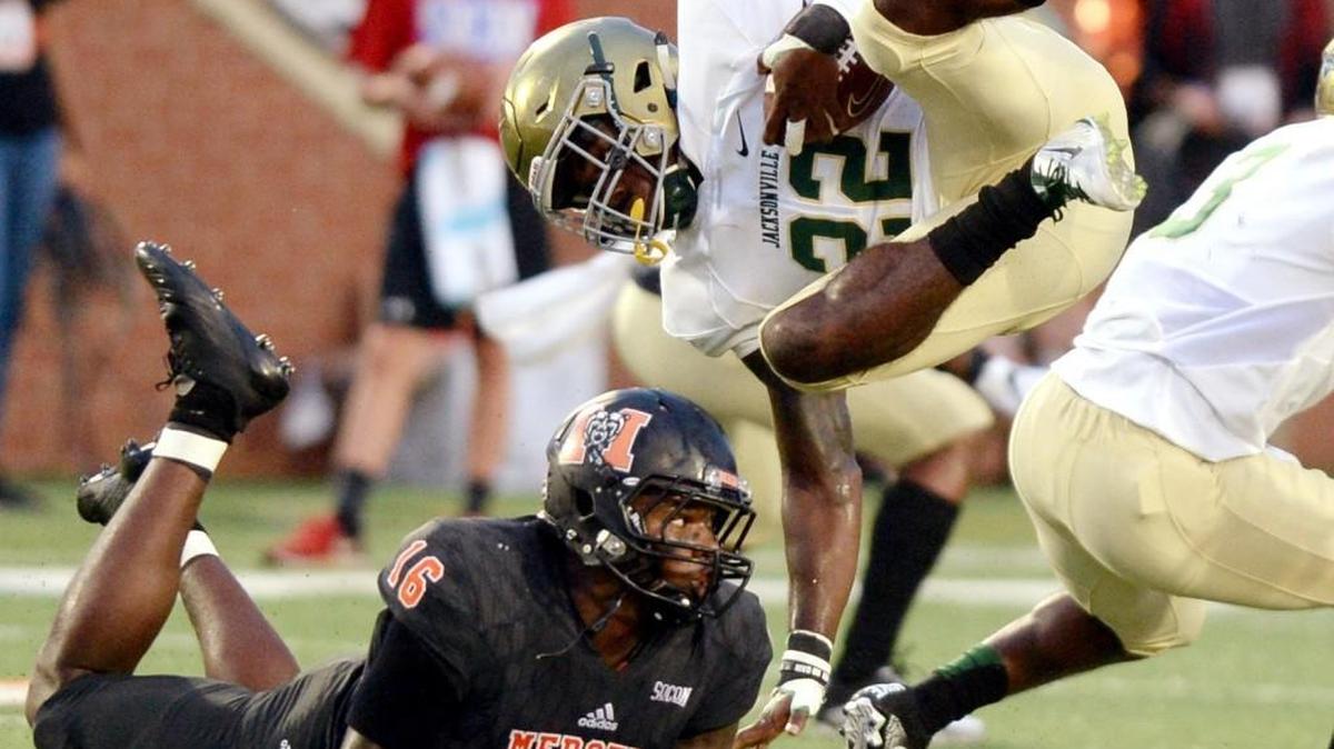 Mercer linebacker LeMarkus Bailey (16) upends Jacksonville running back Irvin Riley (22) behind the one of scrimmage during their game earlier this season.