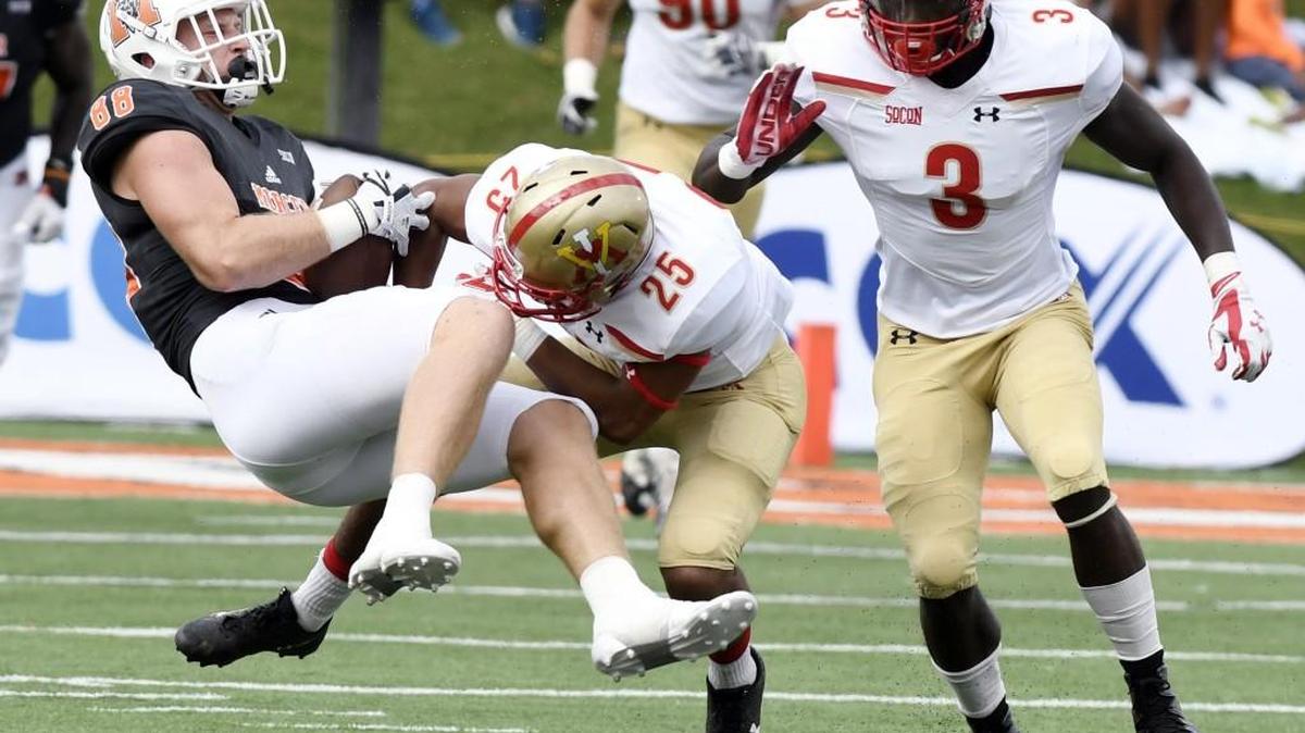 Mercer tight end Chris Ellington (88) hangs onto the ball while being knocked down by VMI's A.J. Smith (25) during their game last season.