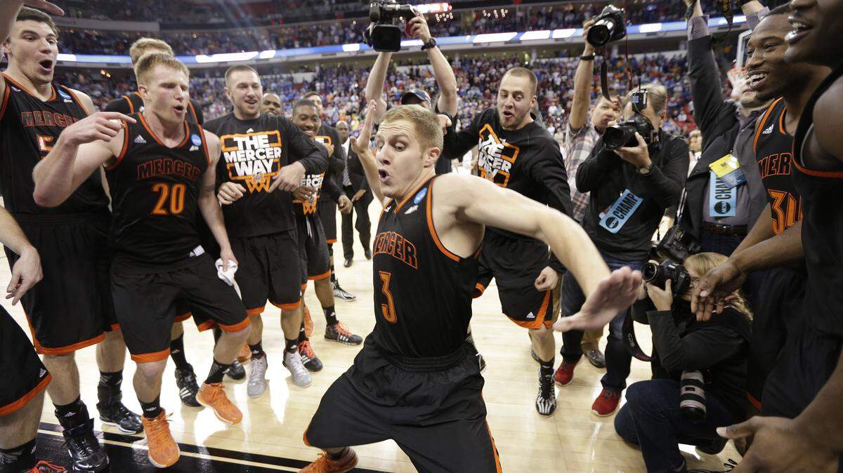Mercer guard Kevin Canevari (3) dances with teammates after the second half of an NCAA college basketball second-round game against Duke, Friday, March 21, 2014, in Raleigh, N.C. Mercer won 78-71.