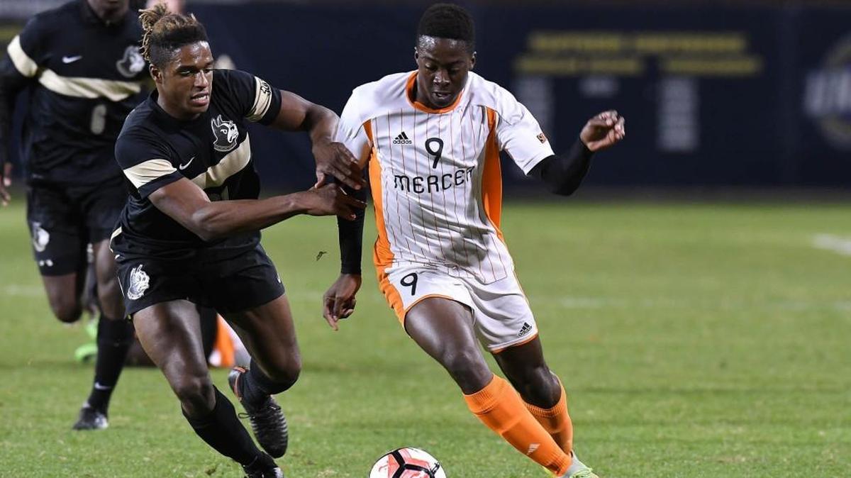 Mercer University forward Will Bagrou attacks the ball in a game against Wofford.