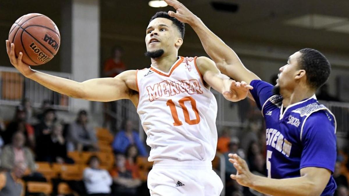 Mercer guard Ria’n Holland (10) puts up a shot over Western Carolina’s Devin Peterson (5) during a game last season.