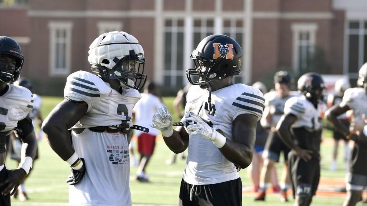 Lee Bennett, left, and LeMarkus Bailey go over strategy at Mercer’s practice Wednesday.