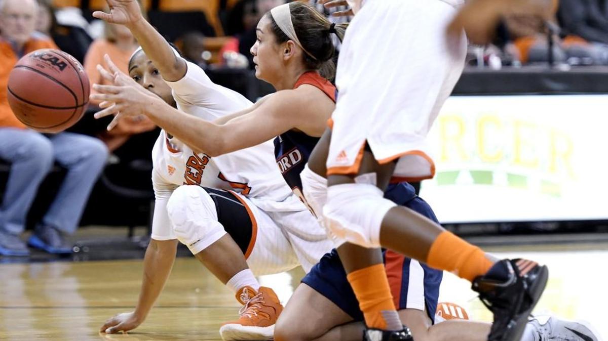 Mercer guard Sydni Means (1) attempts to take the ball away from Samford guard Brittany Stevens (13) during a game last season. .
