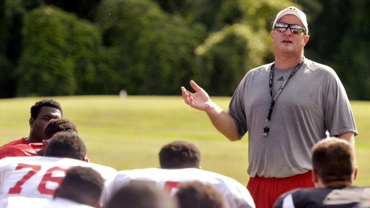 GMC head coach Bert Williams talks to his team at the end of practice August 11.