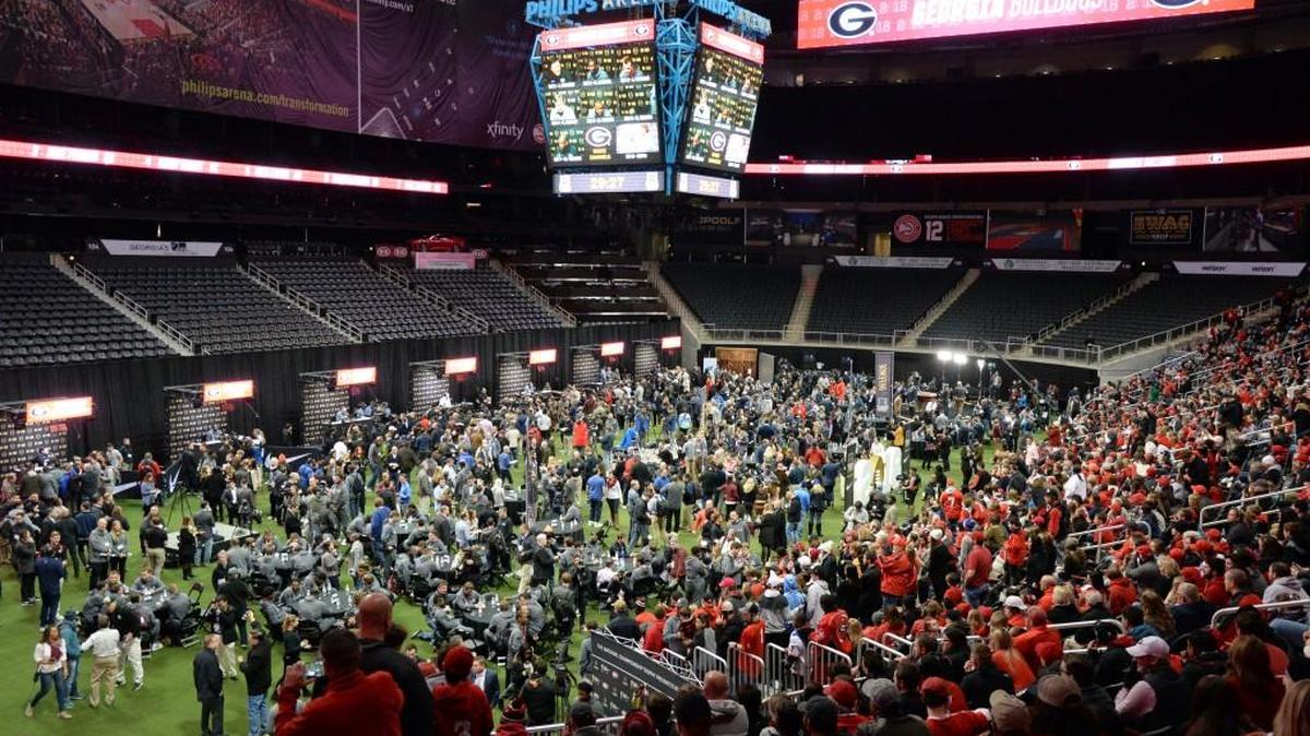 Georgia fans catch a glimpse of their favorite player during National Championship Media Day inside Philips Arena on Saturday morning.