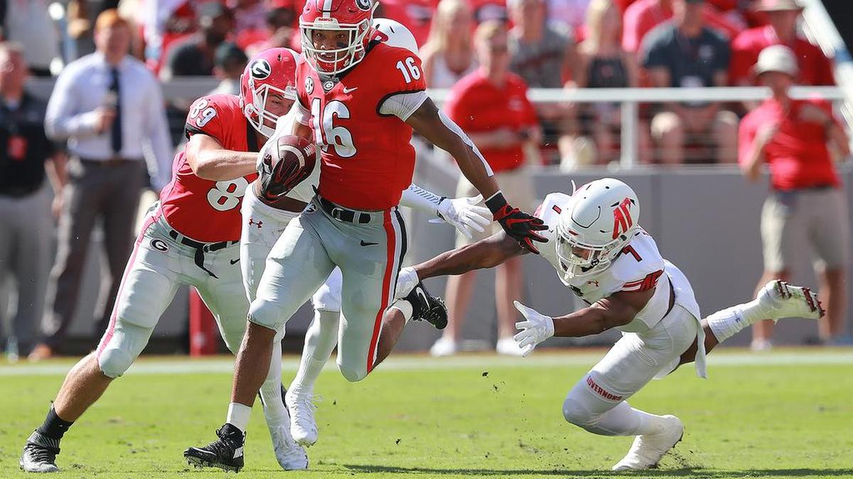 Georgia wide receiver Demetris Robertson (16) breaks away from Austin Peay defensive back Malik Davis for a touchdown and a 24-0 lead during the second quarter of Saturday game at Sanford Stadium in Athens.