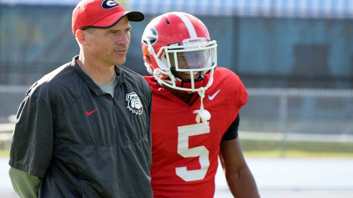 John Lilly is pictured in a practice with receiver Terry Godwin.