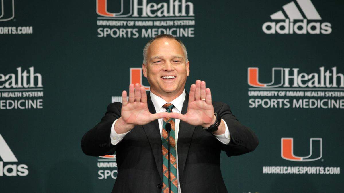Miami head coach Mark Richt throws up "The U" symbol during his introductory news conference. 