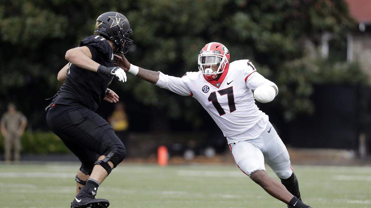 Davin Bellamy rushes the passer against Vanderbilt sporting a club over his left hand. 