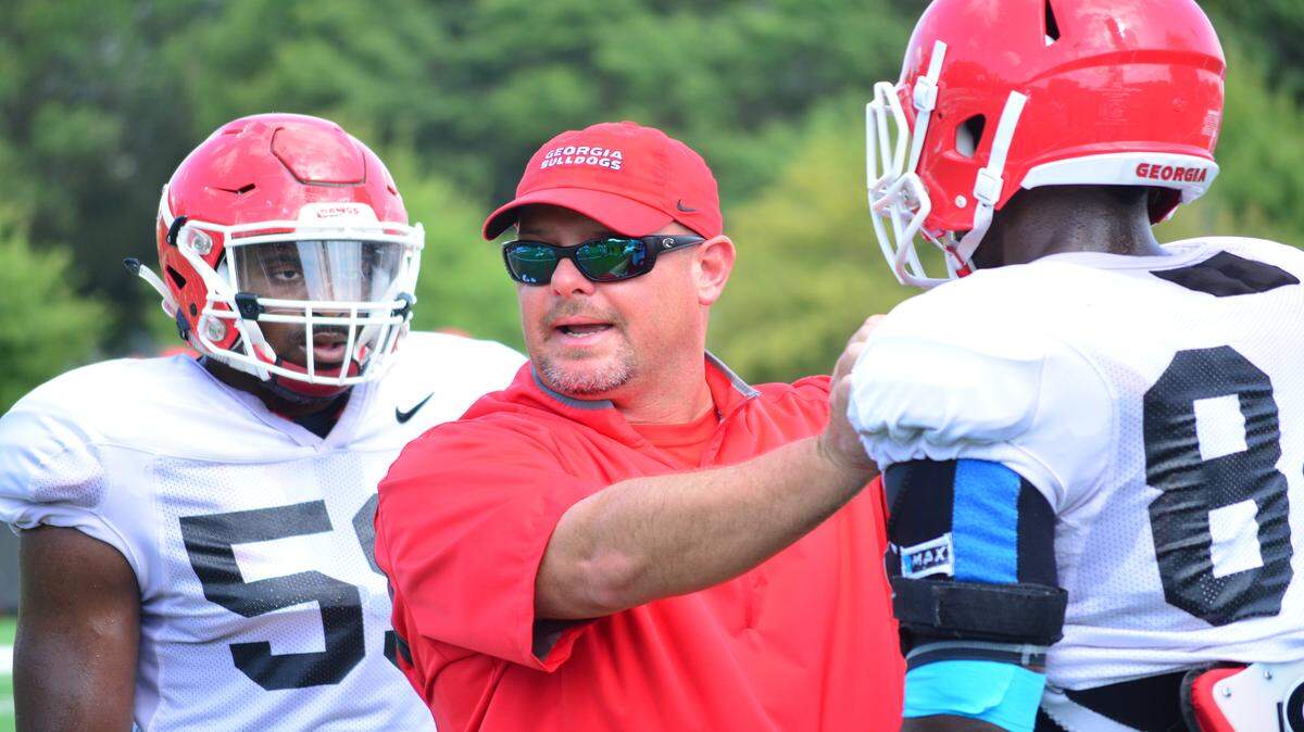 Kevin Sherrer instructs the outside linebackers during an early-season practice. 