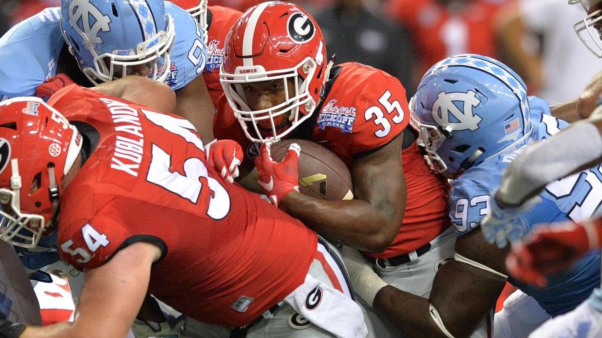 UGA running back Brian Herrien carves his way up the middle against North Carolina.