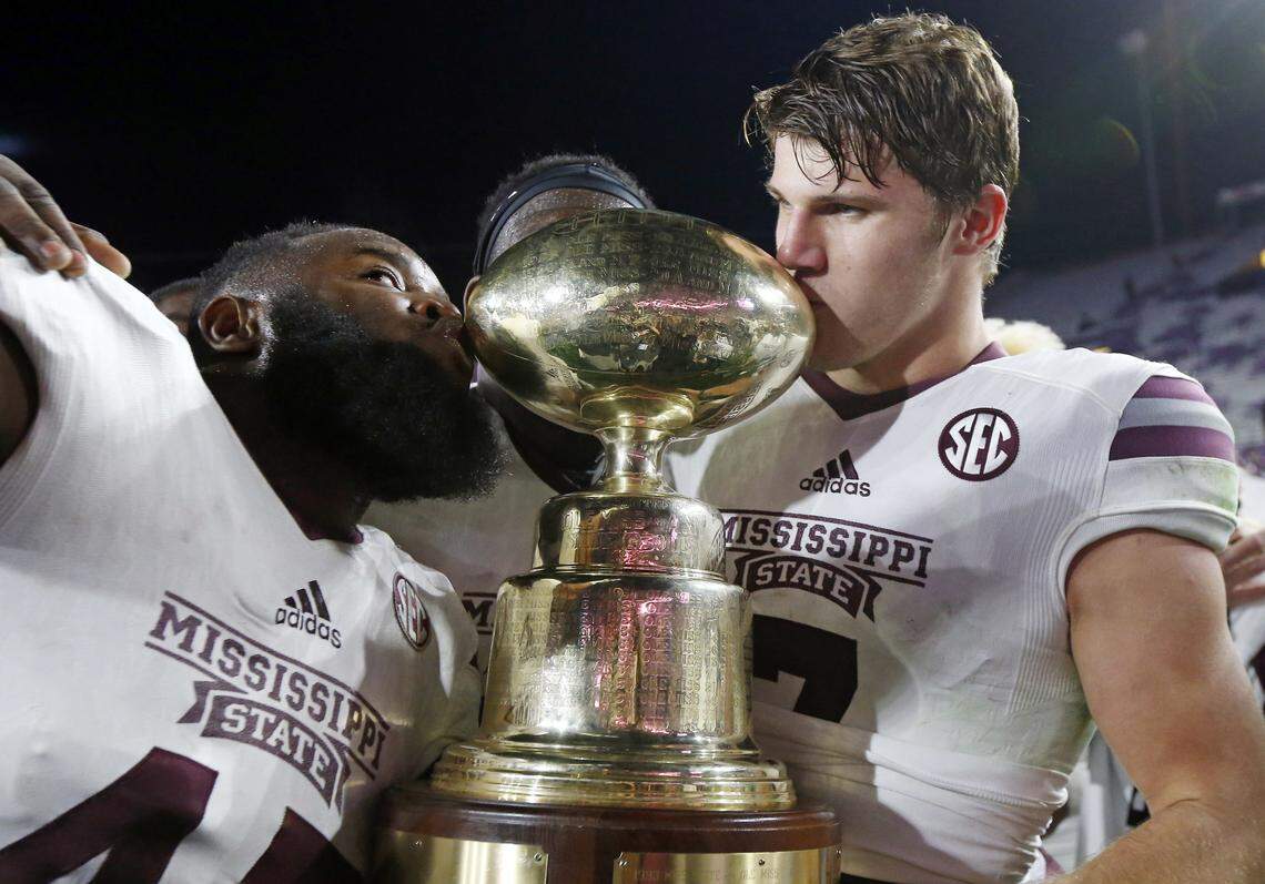 MSU quarterback Nick Fitzgerald (right) and graduated defensive lineman A.J. Jefferson. 