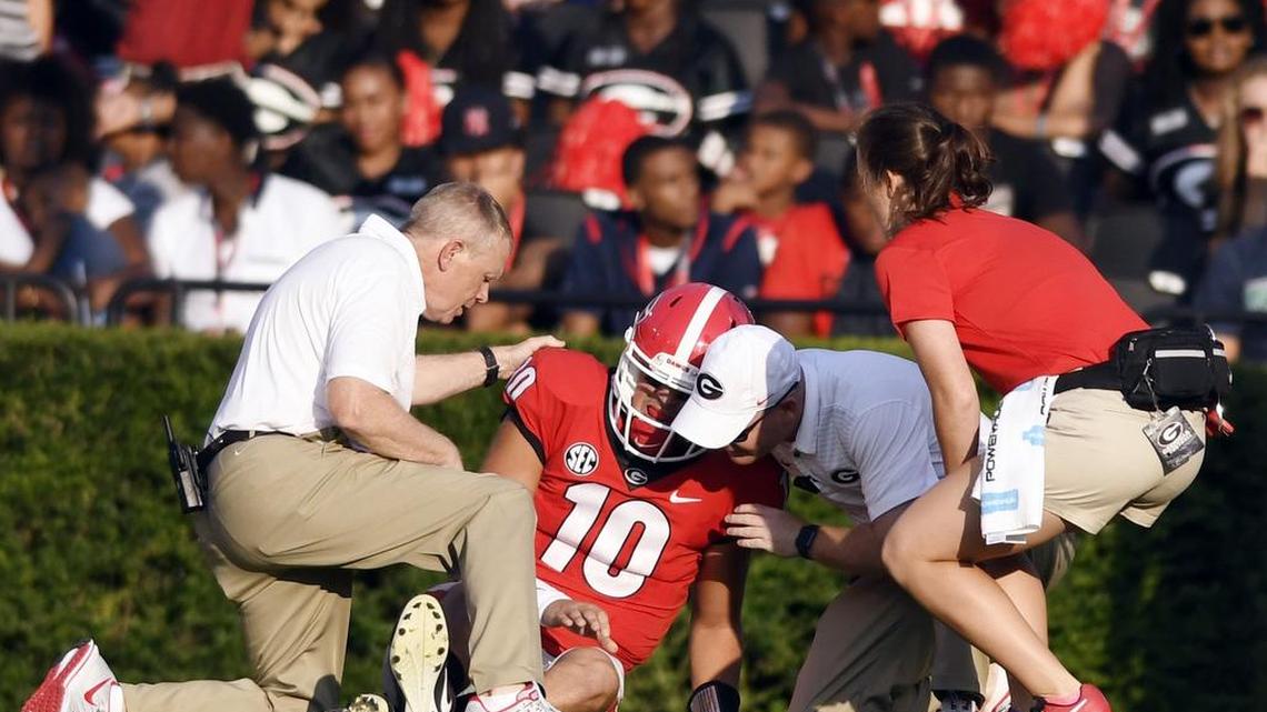 Georgia quarterback Jacob Eason (10) lies on the ground after being injured during the first quarter of Bulldogs' opening game against Appalachian State Saturday.