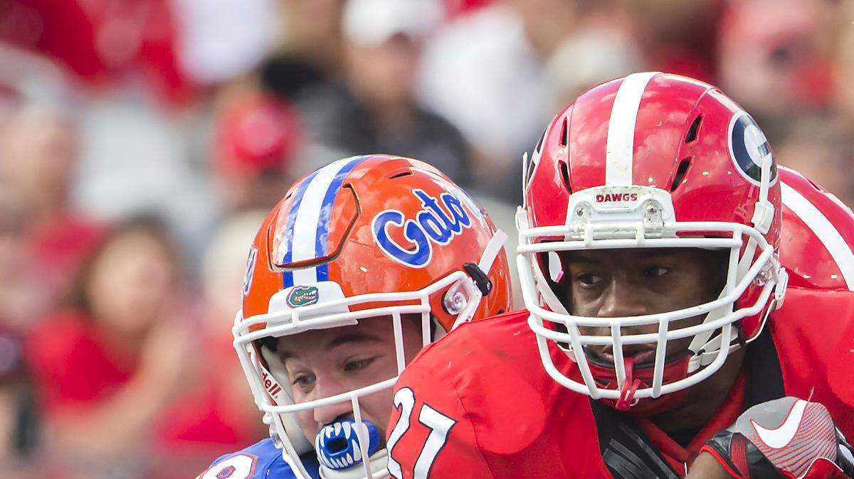 Nick Chubb tries to fight through two Florida defenders during Saturday's loss to the Gators. 