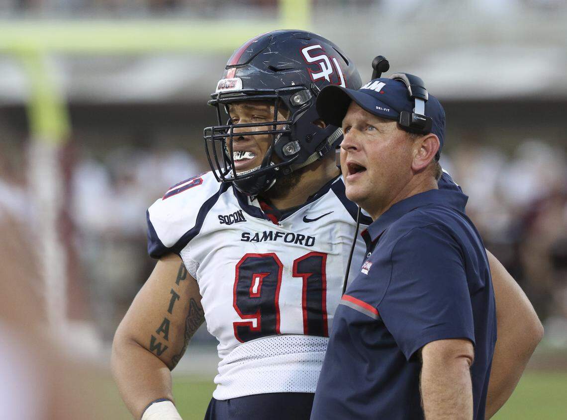 Samford head coach Chris Hatcher and now-graduated defensive lineman Jared Holloway.