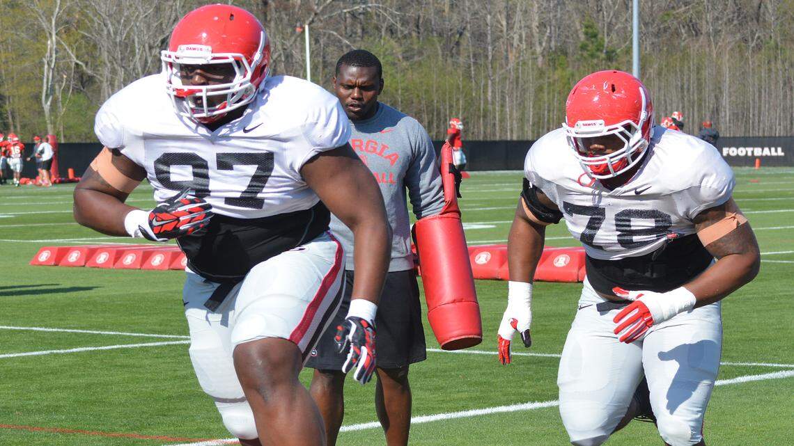 John Atkins (97) and Trent Thompson (78) go through a drill during spring practice. 