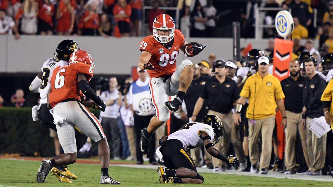 Charlie Woerner hurdles over a Missouri defender.