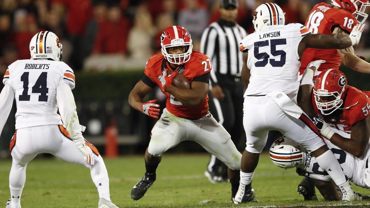 Georgia running back Nick Chubb (27) takes a carry in last year’s game against Auburn.