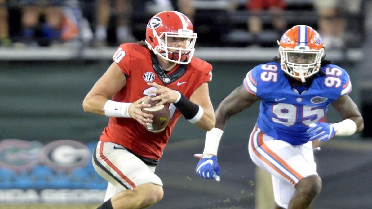 Georgia quarterback Jacob Eason scrambles with the ball against Florida. 