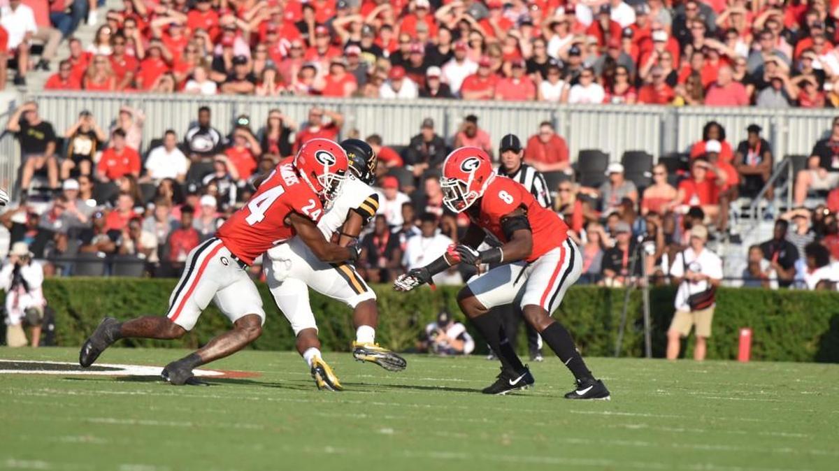 Georgia strong safety Dominick Sanders (24) records a tackle against Appalachian State.