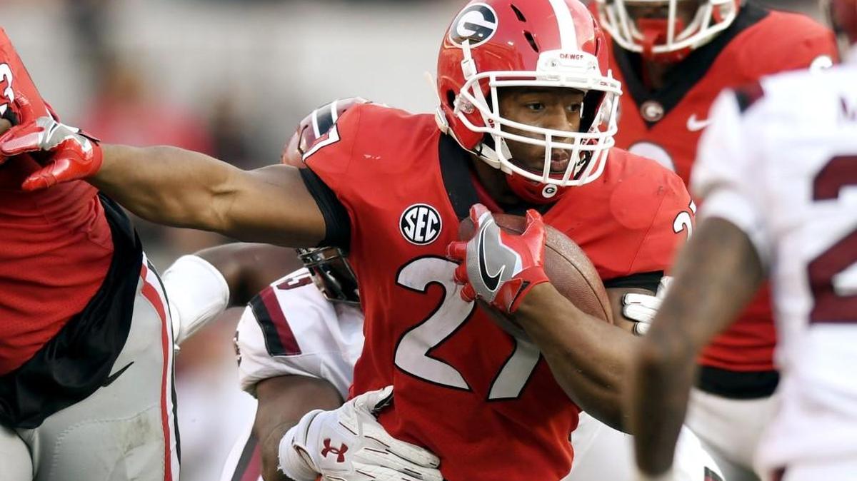 Georgia running back Nick Chubb (27) breaks through the line of scrimmage during their game against South Carolina.