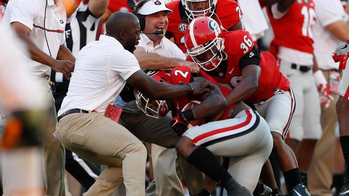 Georgia head coach Kirby Smart and others celebrate with Maurice Smith after an interception against Tennessee. Smith was a graduate transfer who came to UGA from Alabama.