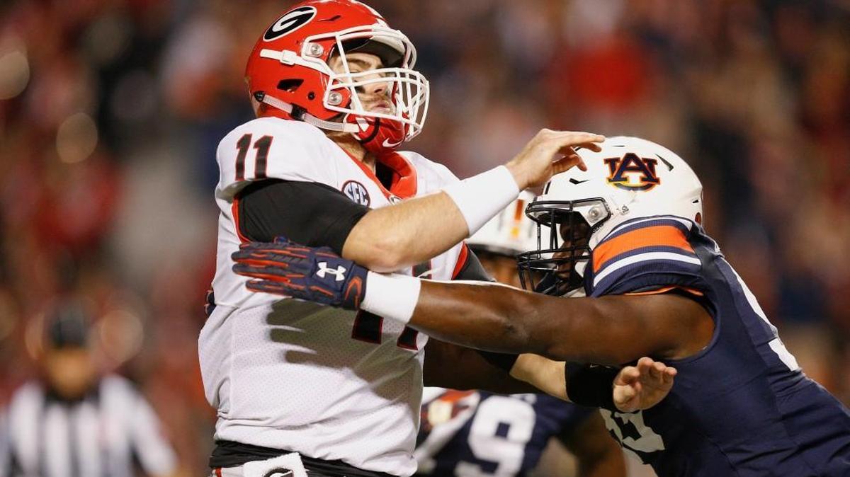 Georgia quarterback Jake Fromm is tackled by Auburn linebacker K.J. Britt.