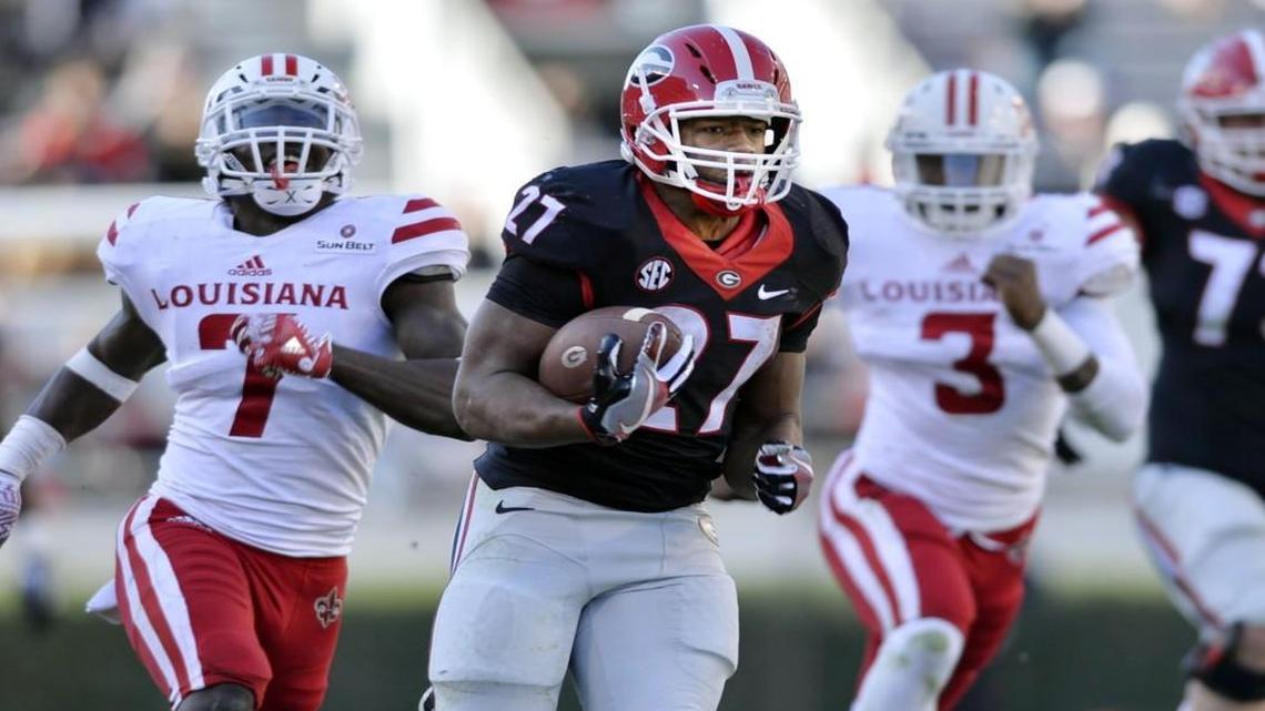 Georgia running back Nick Chubb (27) turns a short pass into a 49-yard touchdown during fourth-quarter action Saturday against Louisiana-Lafayette.