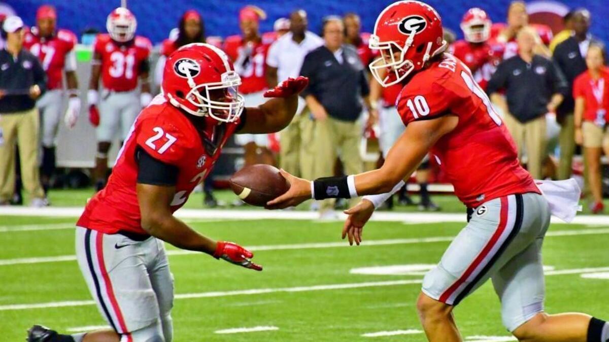 Quarterback Jacob Eason (10) is among those happy to have running back Nick Chubb (27) back to the team in 2017.