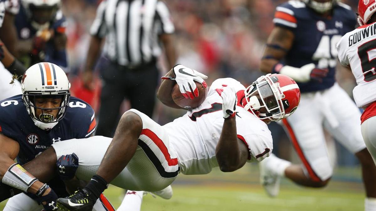 Auburn defensive back Carlton Davis tackles Georgia running back Sony Michel.