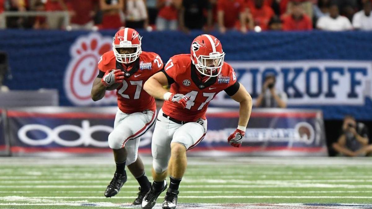 Georgia tailback Nick Chubb (27) runs behind fullback Christian Payne during the Bulldogs’ win over North Carolina on Saturday.