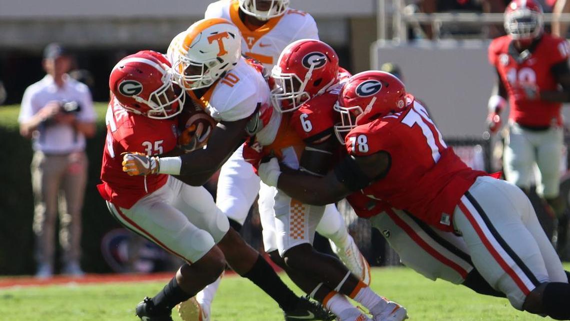 Pictured making a tackle against Tennessee are Aaron Davis, Natrez Patrick and Trenton Thompson. All three will be back in 2017.