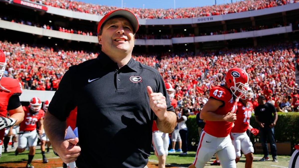 Georgia first-year head coach Kirby Smart runs into a packed Sandford Stadium at this year’s annual G-Day spring football game.