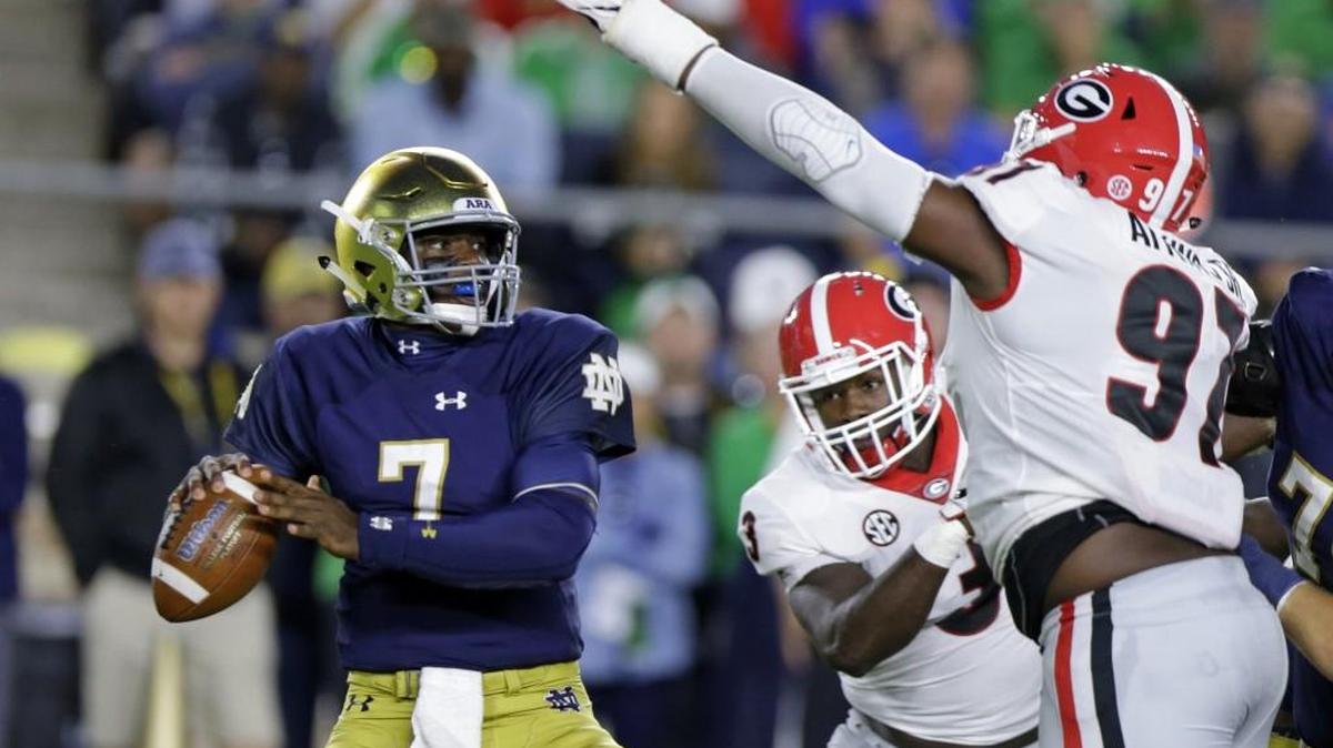 Notre Dame quarterback Brandon Wimbush (7) looks to throw over Georgia nose tackle John Atkins during the first half of Saturday’s game.