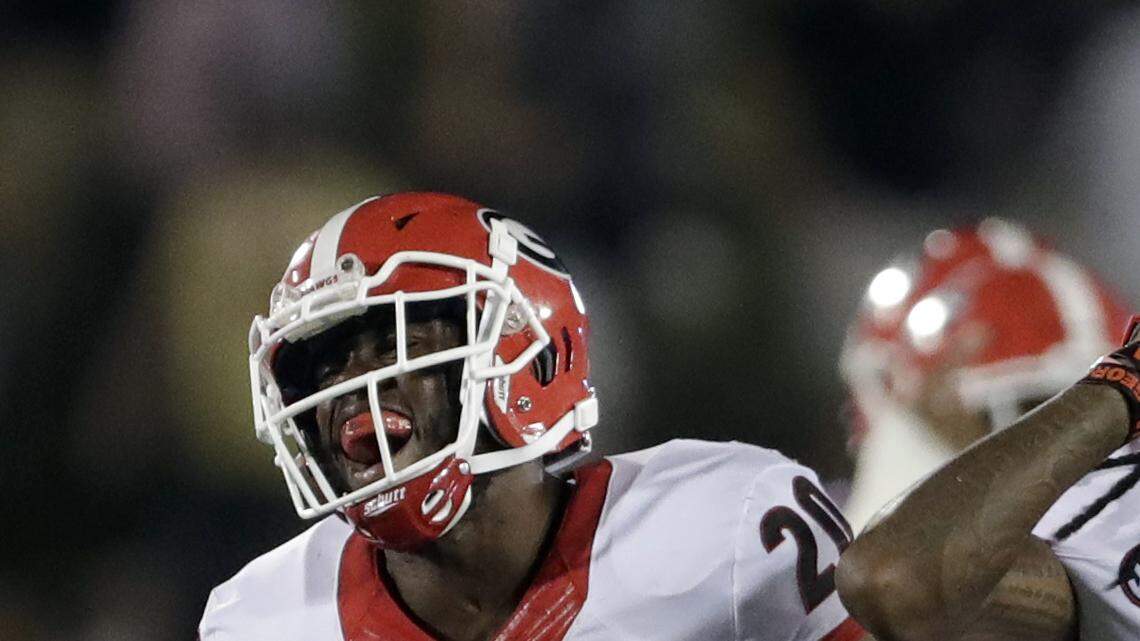 Juwuan Briscoe (12) celebrates with Quincy Mauger (20) after recovering a game-sealing fumble against Missouri. 