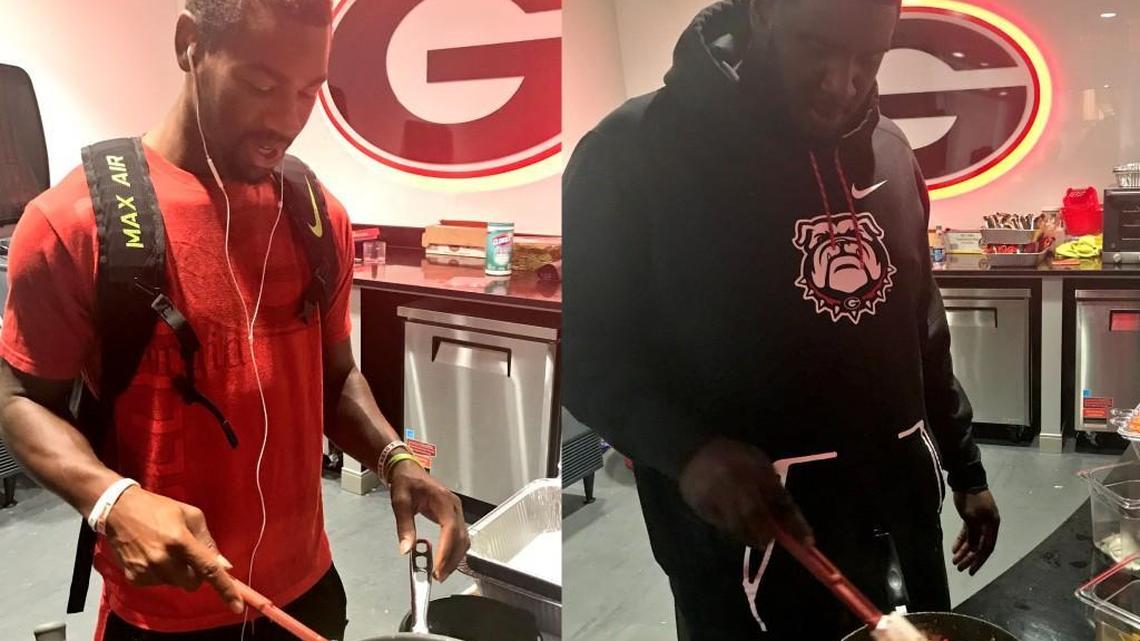 Terry Godwin (left) and Julian Rochester (right) cook meals at their indoor athletic facility’s breakfast station.