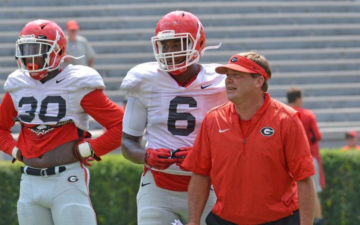 Georgia head coach Kirby Smart is photographed with linebackers Tae Crowder (30) and Natrez Patrick (6).